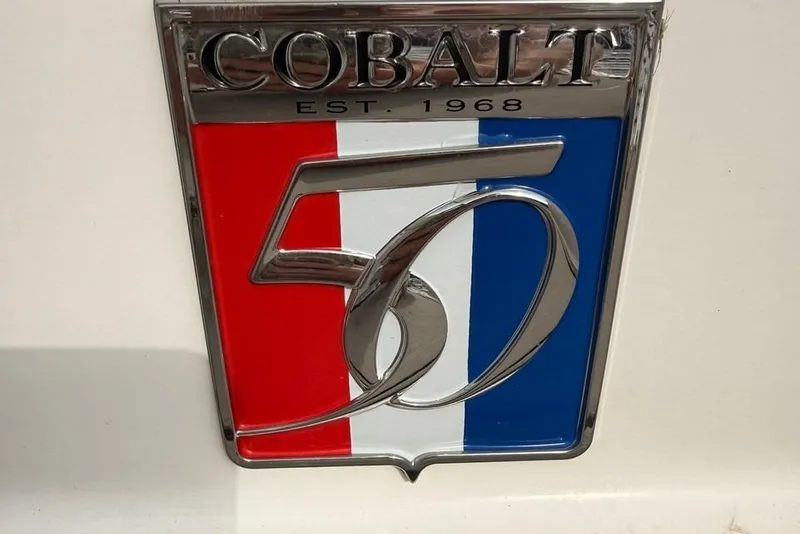 Slide: The Image of Cobalt 50th anniversary emblem on 2018 R5 WSS Surf boat, featuring red, white, and blue design. - 41