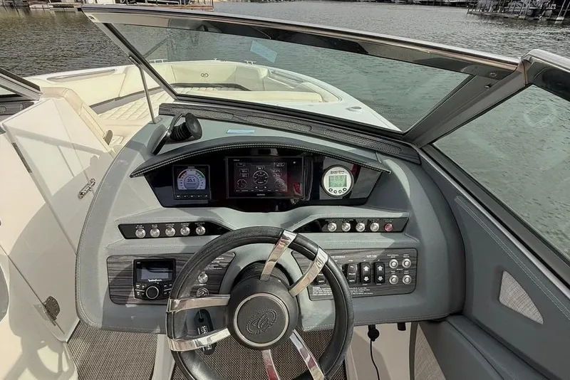 Slide: The Image of 2018 Cobalt R5 WSS Surf boat dashboard with steering wheel and control panel. - 5