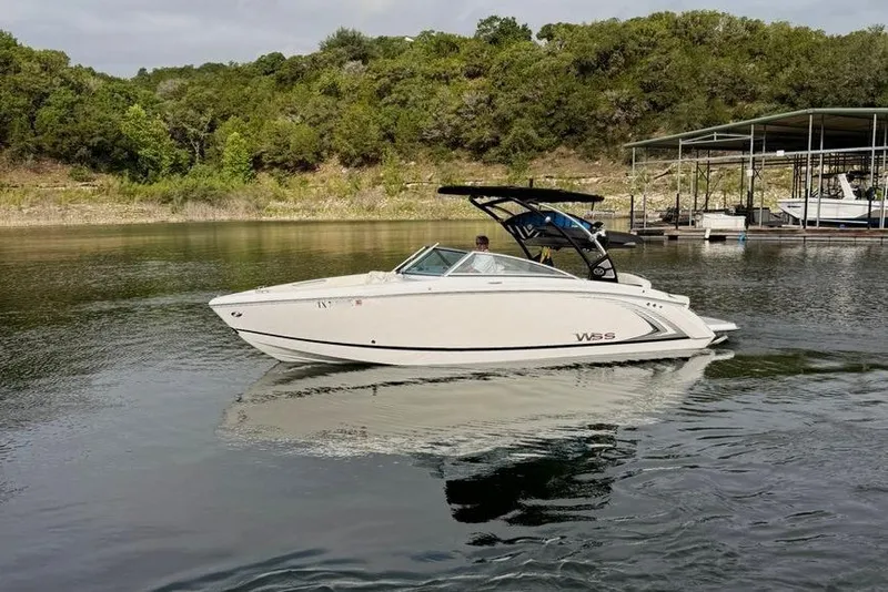 Slide: The Image of 2018 Cobalt R5 WSS Surf boat on calm lake with lush green shoreline. - 6