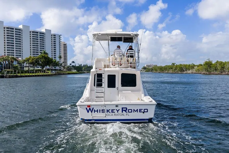 Slide: The Image of 2005 Luhrs 38 Convertible boat cruising in Boca Raton, Florida waterway. - 11