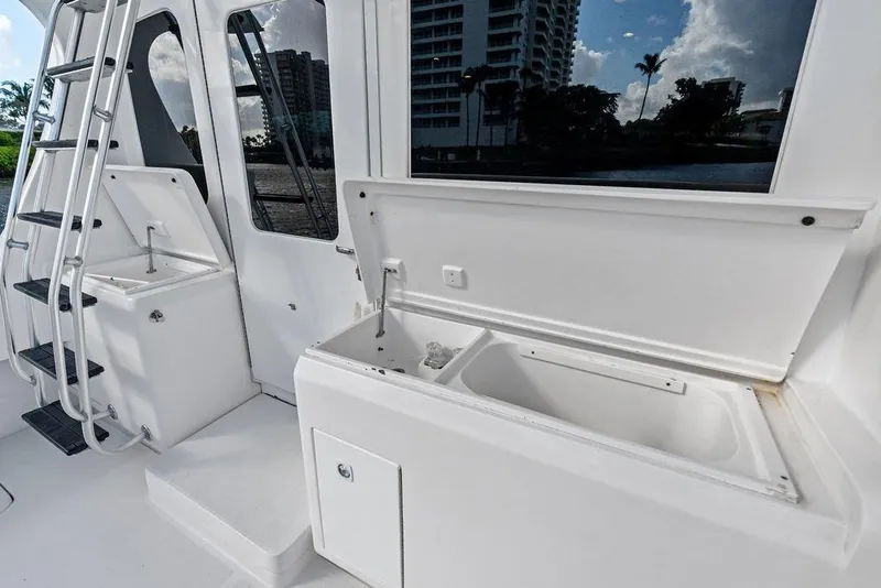 Slide: The Image of 2005 Luhrs 38 Convertible yacht deck with storage compartments and ladder. - 23