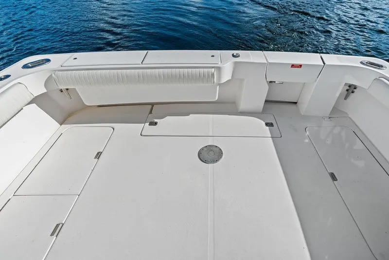 Slide: The Image of Spacious deck of 2005 Luhrs 38 Convertible boat with white seating and storage compartments. - 24