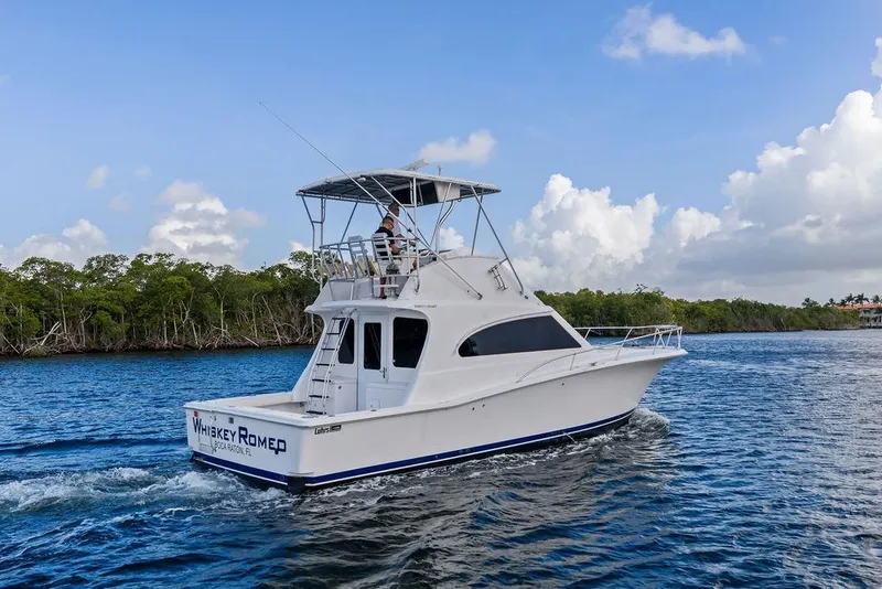Slide: The Image of 2005 Luhrs 38 Convertible yacht cruising on a scenic waterway. - 3