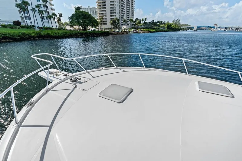 Slide: The Image of Bow view of 2005 Luhrs 38 Convertible yacht on calm water near buildings. - 30
