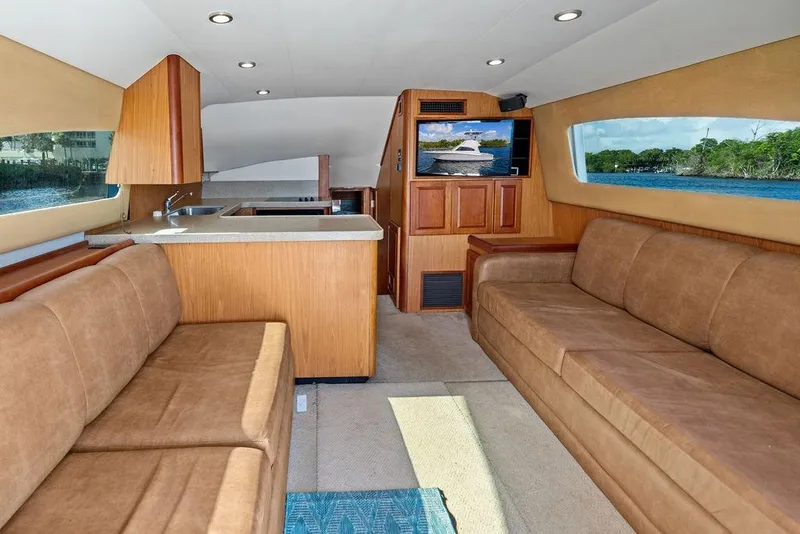 Slide: The Image of Luxurious interior of 2005 Luhrs 38 Convertible yacht with sofas and kitchenette. - 33