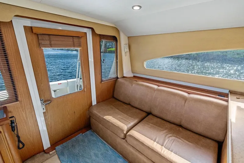 Slide: The Image of Interior of 2005 Luhrs 38 Convertible yacht with brown sofa and water view. - 36