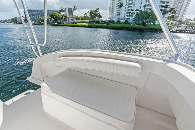 Slide: The Image of 2005 Luhrs 38 Convertible boat interior with waterfront view and white seating. - 39