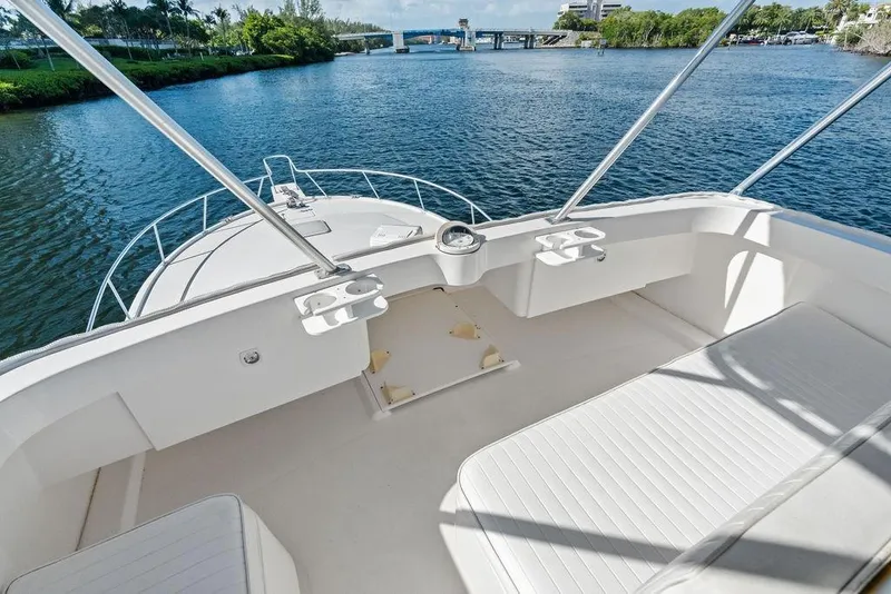 Slide: The Image of 2005 Luhrs 38 Convertible yacht deck overlooking serene waterway and lush greenery. - 40