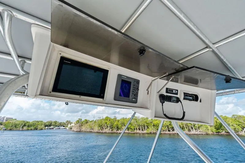 Slide: The Image of 2005 Luhrs 38 Convertible boat electronics panel with navigation and communication devices. - 42