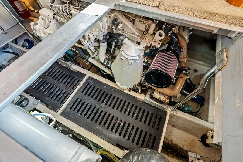 Slide: The Image of Engine compartment of a 2005 Luhrs 38 Convertible boat, showcasing mechanical components. - 46