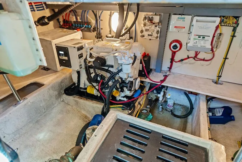 Slide: The Image of Engine room of 2005 Luhrs 38 Convertible boat, showcasing machinery and wiring. - 47