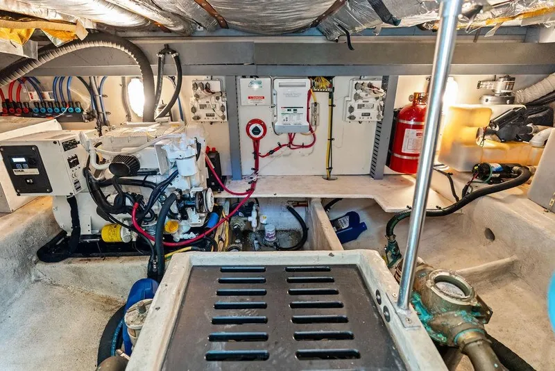 Slide: The Image of Engine room of 2005 Luhrs 38 Convertible boat, featuring mechanical and electrical systems. - 48