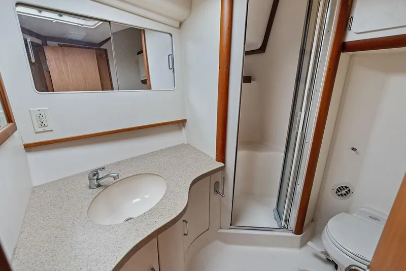 Slide: The Image of 2005 Luhrs 38 Convertible yacht bathroom with sink, mirror, shower, and toilet. - 54