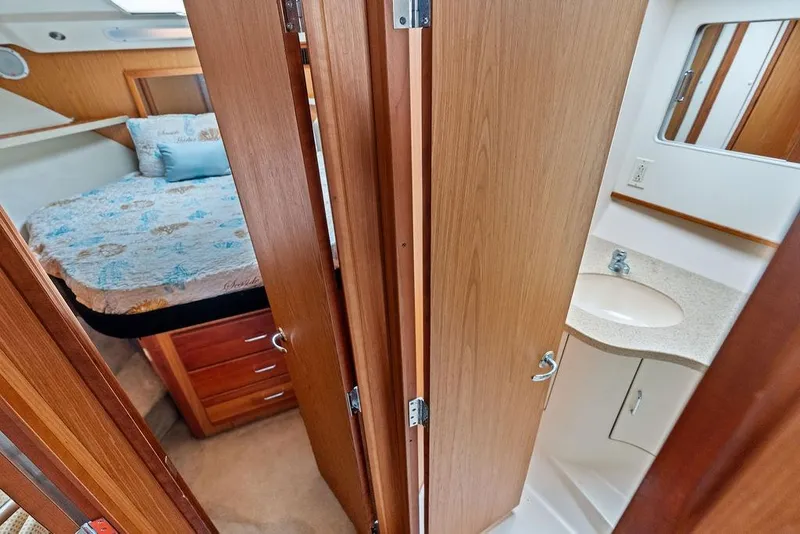 Slide: The Image of 2005 Luhrs 38 Convertible interior with bedroom and bathroom view. - 56
