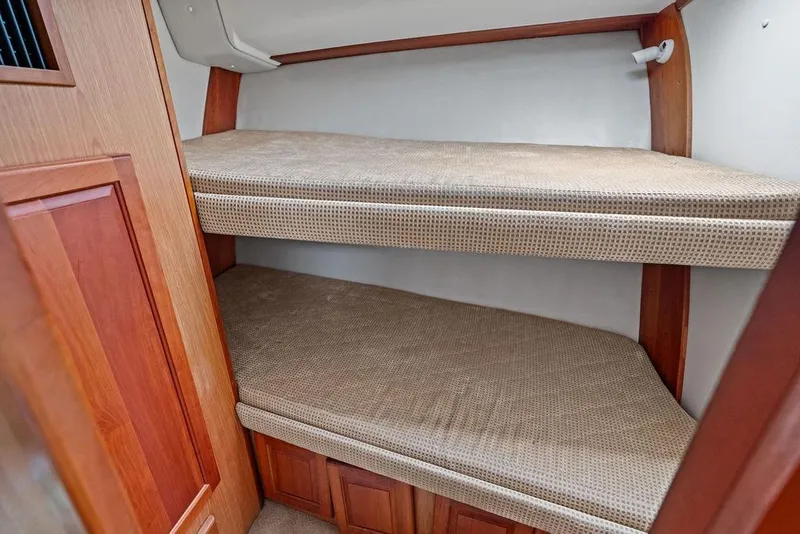 Slide: The Image of 2005 Luhrs 38 Convertible boat interior with wooden bunk beds. - 57