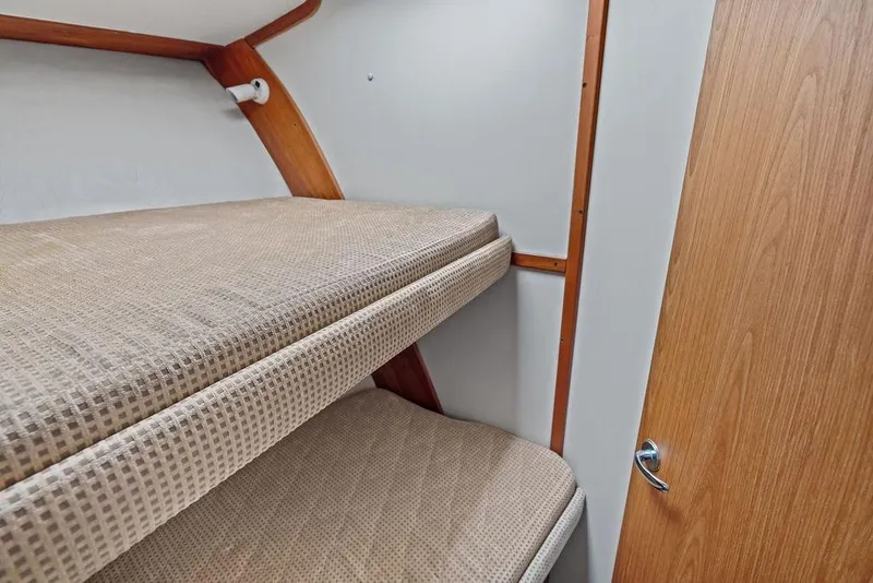 Slide: The Image of Bunk beds in 2005 Luhrs 38 Convertible yacht cabin with wooden accents. - 58