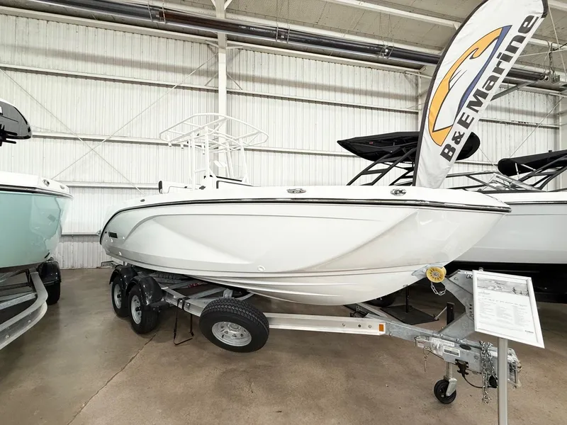 The Image of 2025 Yamaha Boats 220 FSH Sport on trailer in showroom. - 0