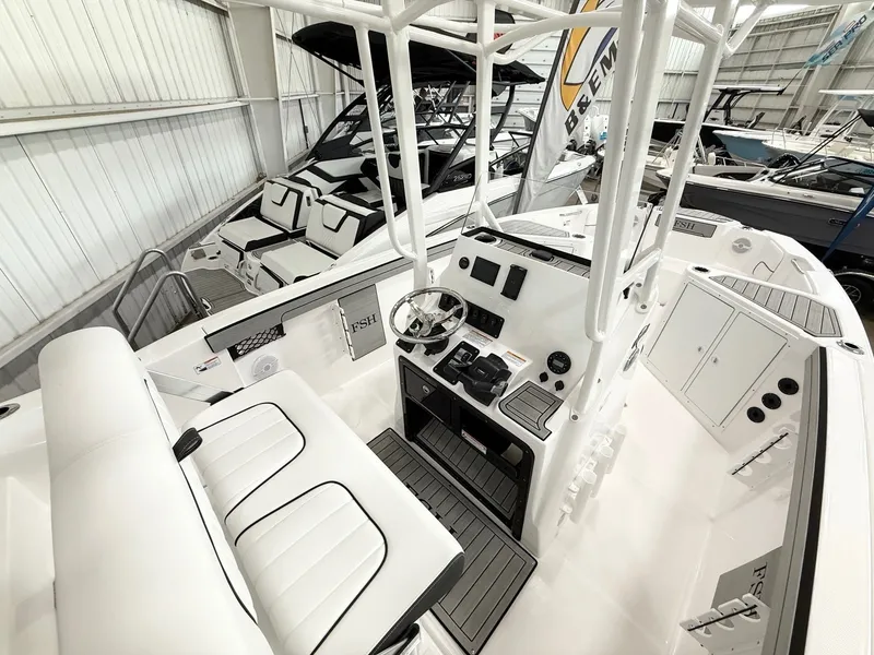 Slide: The Image of Interior view of 2025 Yamaha Boats 220 FSH Sport with helm station. - 5
