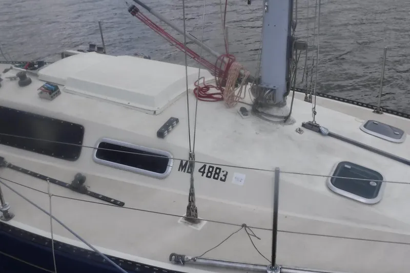 Slide: The Image of 1975 Carter 3/4 Ton sailboat on water, featuring deck details and rigging. - 12