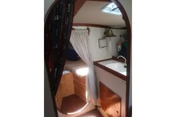 Slide: The Image of 1975 Carter 3/4 Ton boat interior with sink, bed, and skylight. - 17