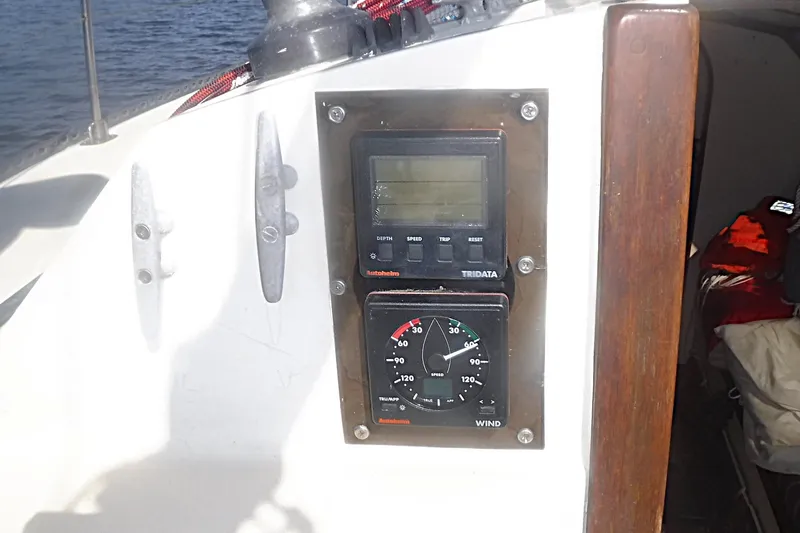 Slide: The Image of Sailing instrument panel on a 1975 Carter 3/4 Ton boat, featuring depth and wind gauges. - 21