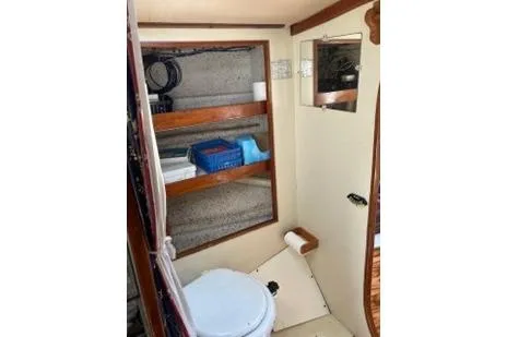 Slide: The Image of 1975 Carter 3/4 Ton boat interior bathroom with shelves and toilet. - 22
