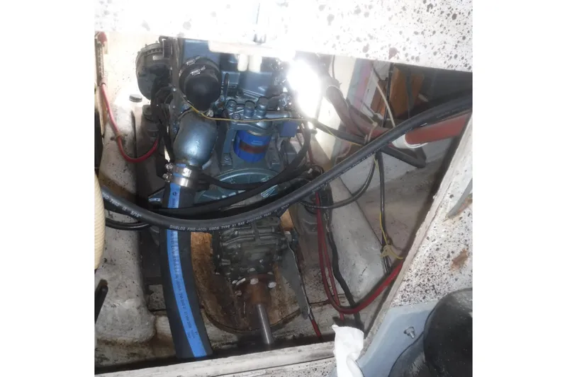 Slide: The Image of 1975 Carter 3/4 Ton engine compartment with visible wiring and hoses. - 23