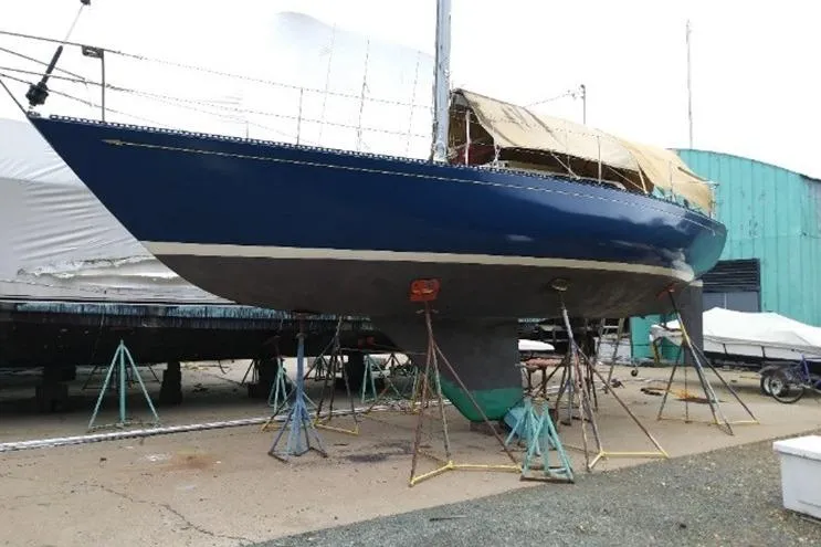 Slide: The Image of 1975 Carter 3/4 Ton sailboat on stands in a boatyard. - 3