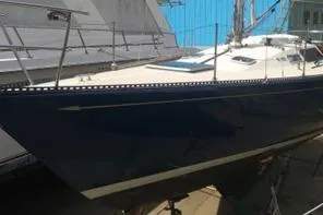 Slide: The Image of 1975 Carter 3/4 Ton sailboat with sleek blue hull in dry dock. - 5