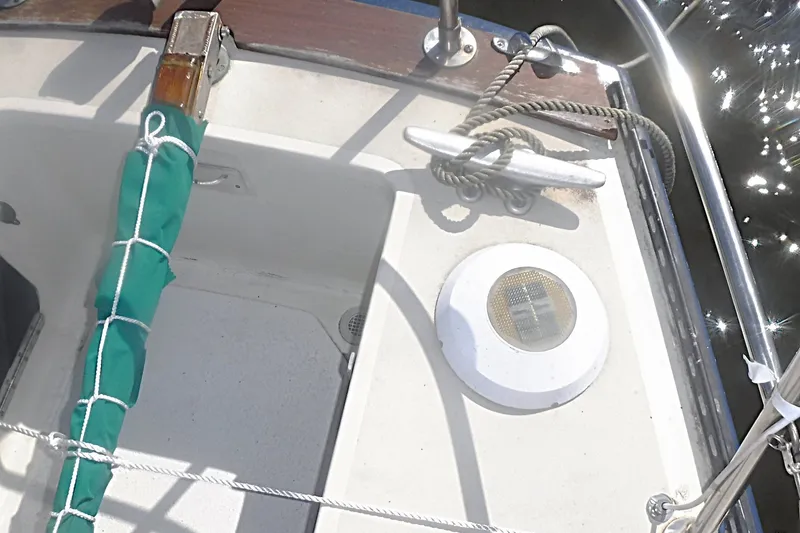 Slide: The Image of 1975 Carter 3/4 Ton sailboat cockpit with green cover and rope details. - 19