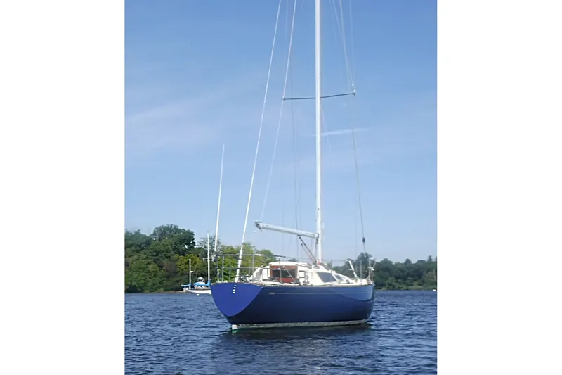 Slide: The Image of 1975 Carter 3/4 Ton sailboat on calm water, clear sky background. - 3