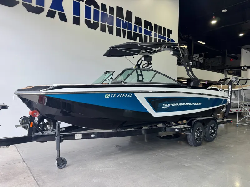 Slide: The Image of 2019 Nautique Super Air Nautique GS22 boat in showroom. - 2