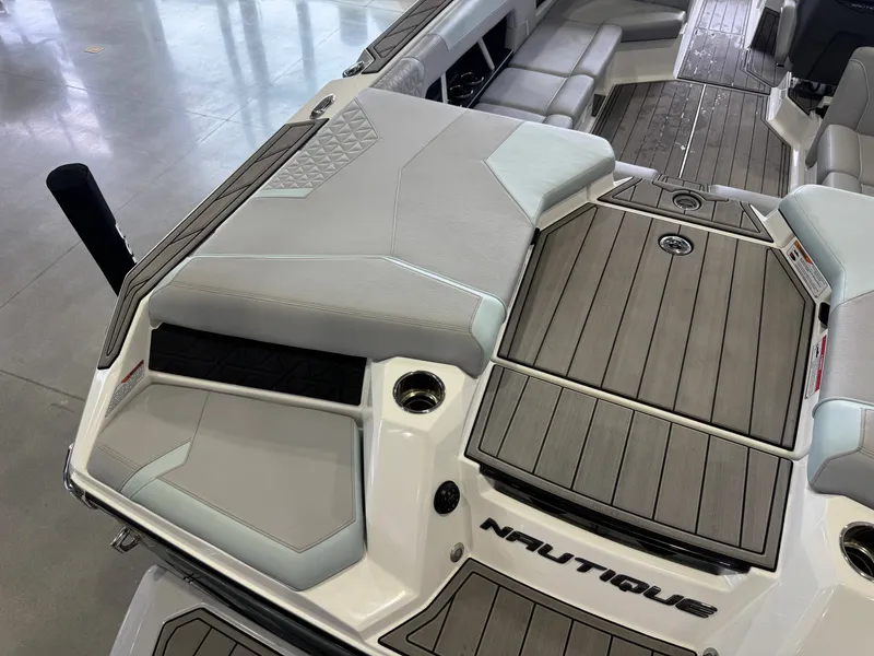 Slide: The Image of 2023 Nautique Super Air Nautique GS22 boat rear seating area. - 12