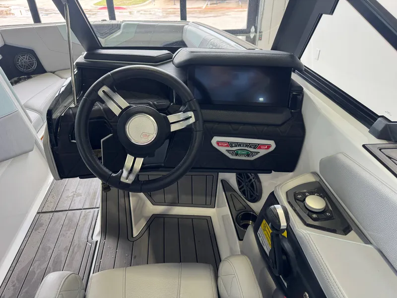 Slide: The Image of Interior of 2023 Nautique Super Air Nautique GS22 with steering wheel and controls. - 26