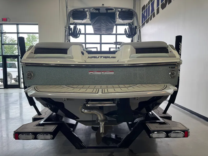 Slide: The Image of Rear view of 2023 Nautique Super Air Nautique GS22 boat in showroom. - 6