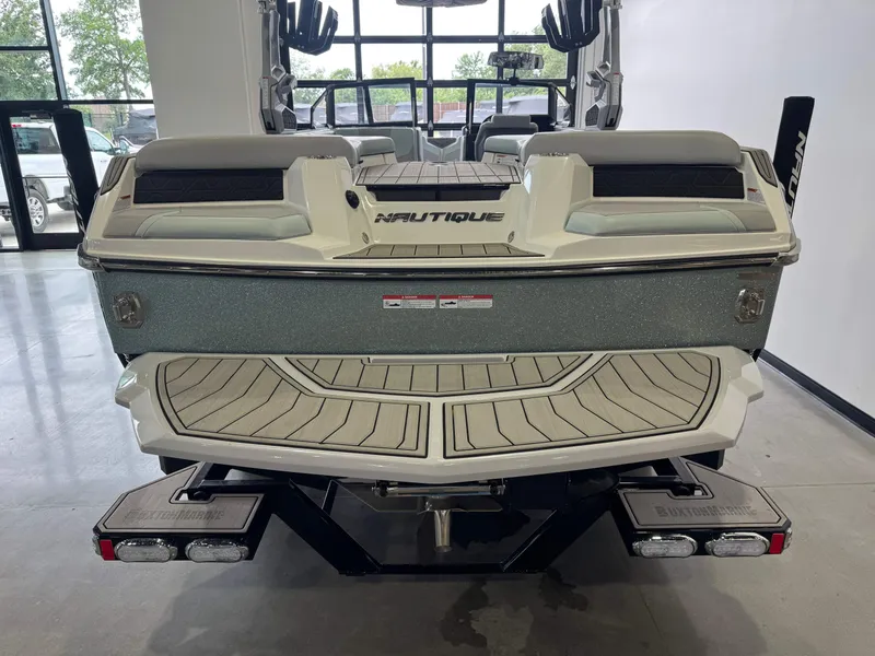 Slide: The Image of Rear view of 2023 Nautique Super Air Nautique GS22 boat in showroom. - 8
