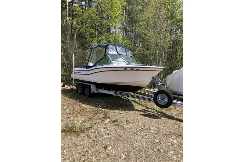 The Image of 1997 Grady-White Tournament 192 boat on trailer in wooded area. - 0