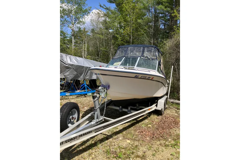 Slide: The Image of 1997 Grady-White Tournament 192 boat on trailer in wooded area. - 2