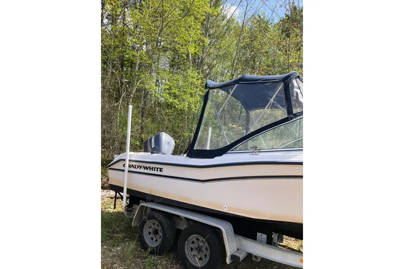 Slide: The Image of 1997 Grady-White Tournament 192 boat on trailer, surrounded by lush greenery. - 4