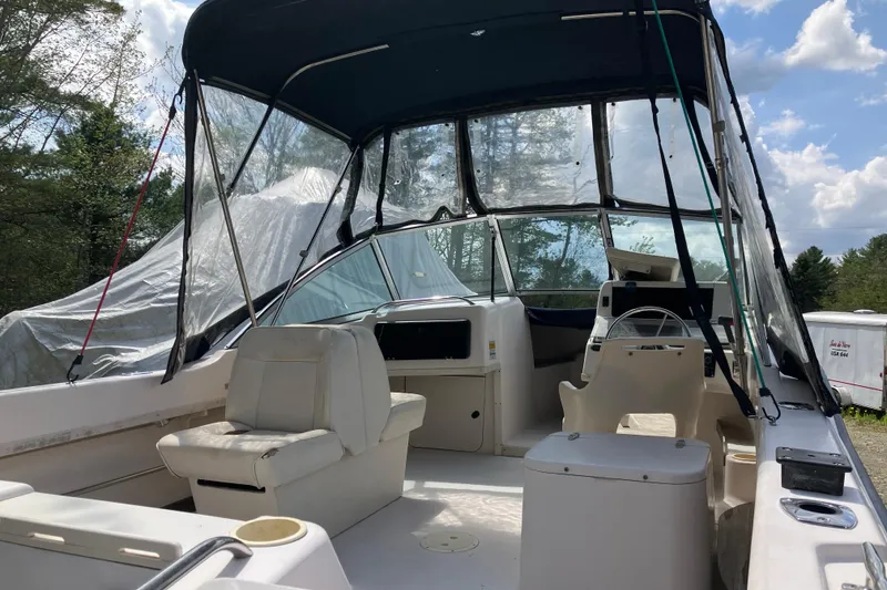 Slide: The Image of 1997 Grady-White Tournament 192 boat interior with seating and steering wheel under canopy. - 5