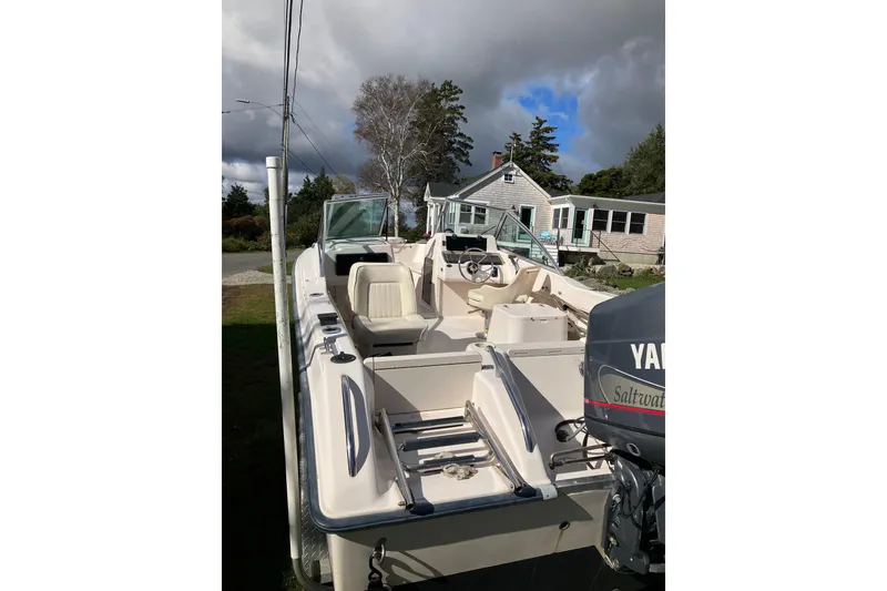 Slide: The Image of 1997 Grady-White Tournament 192 boat with Yamaha engine, parked outdoors under cloudy sky. - 7