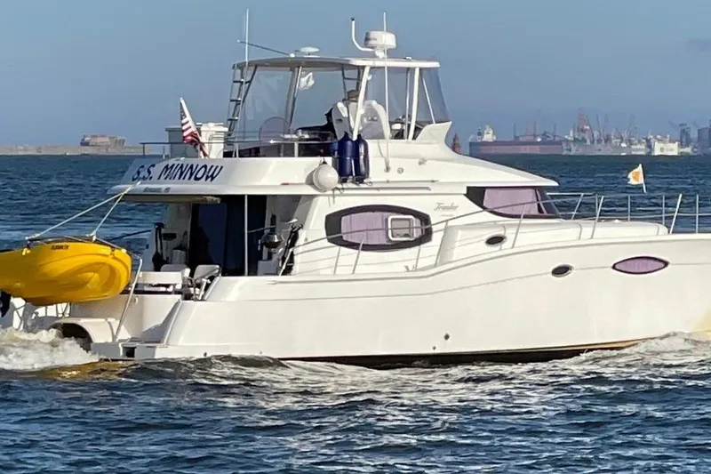The Image of A 2013 Fountaine Pajot Summerland 40 yacht cruising on the water with a yellow kayak. - 1