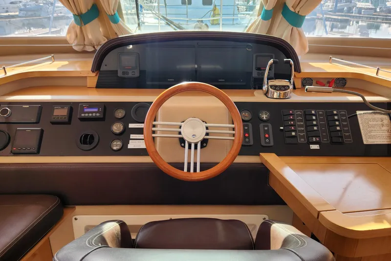 Slide: The Image of Cockpit of 2013 Fountaine Pujut Summerland 40 yacht with steering wheel and control panel. - 11