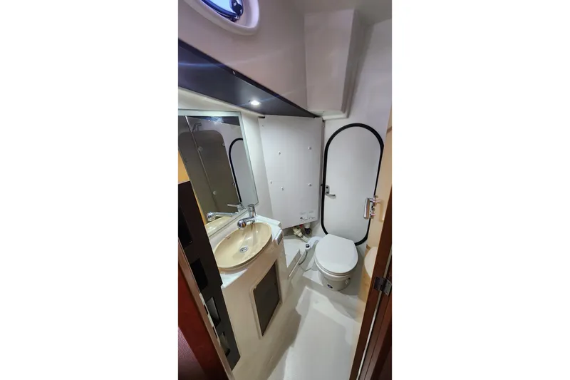 Slide: The Image of Compact bathroom in 2013 Fountaine Pujut Summerland 40 yacht with sink, toilet, and mirror. - 20