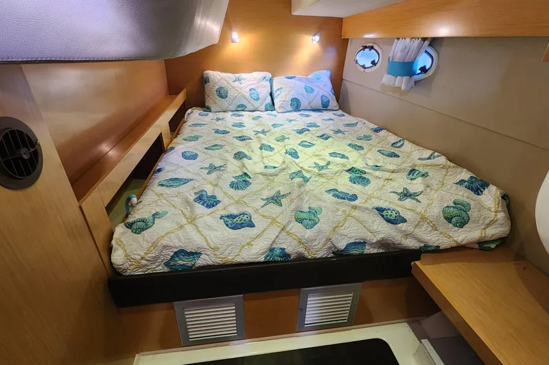 Slide: The Image of Cozy cabin bedroom in 2013 Fountaine Pujut Summerland 40 yacht with nautical-themed bedding. - 23