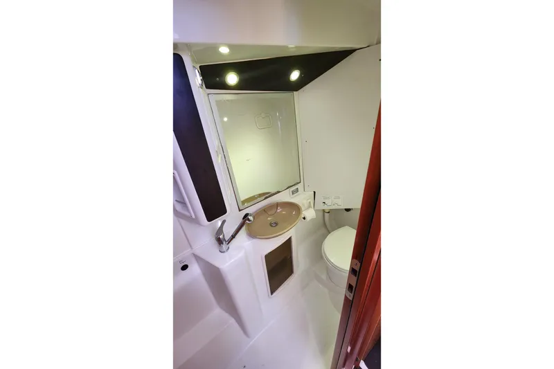 Slide: The Image of Compact bathroom in 2013 Fountaine Pujut Summerland 40 yacht, featuring sink, mirror, and toilet. - 26
