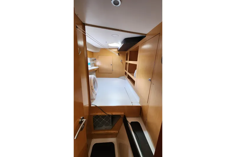 Slide: The Image of Interior of 2013 Fountaine Pujut Summerland 40 yacht with wooden cabinetry and compact design. - 28