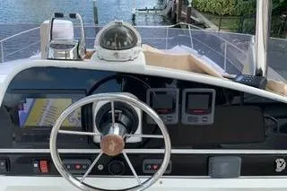 Slide: The Image of Steering console of a 2013 Fountaine Pajot Summerland 40 boat, featuring navigation instruments. - 30