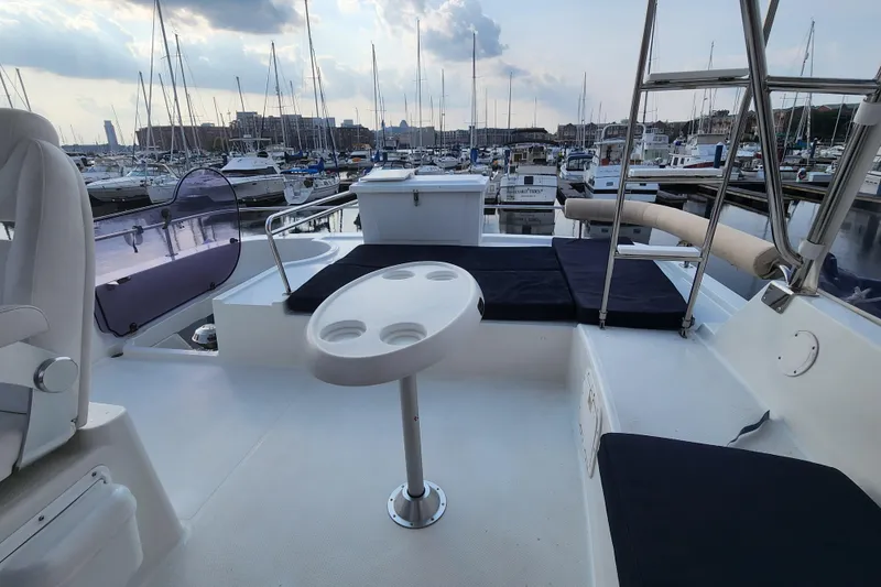 Slide: The Image of 2013 Fountaine Pujut Summerland 40 yacht interior with seating and table, docked in marina. - 32