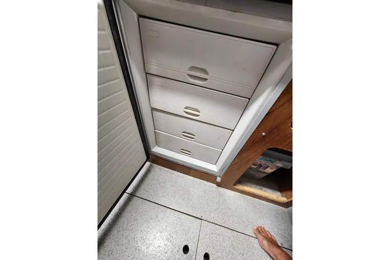 Slide: The Image of Interior view of a 2013 Fountaine Pujut Summerland 40, featuring white storage drawers. - 35